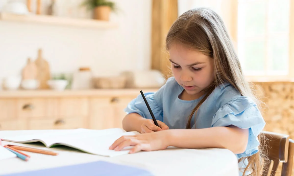 girl is writing with black pencil