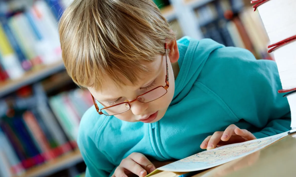 blonde hair child reading book